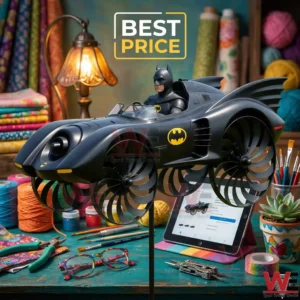 A black Batmobile toy with spinning fan wheels on a busy craft table.
