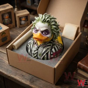 Beetlejuice 38th Anniversary Rubber Duck 3 An open cardboard box containing a Beetlejuice themed duck figure protected by foam! Other boxes and old books are visible on the desk!