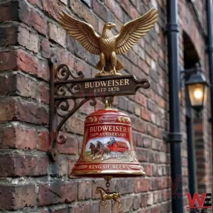 Budweiser 150th Anniversary wall bell with golden eagle mounted on brick wall.