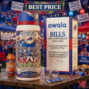 A cream Owala water bottle with a detailed Buffalo Bills anniversary graphic stands next to its white and blue collector edition box on a wooden table. Tailgate party accessories like sauce and a bottle opener are scattered nearby against a busy background of football fans.