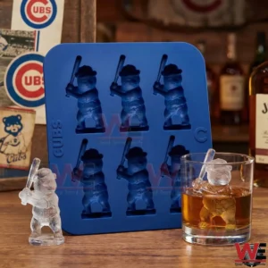 Blue Chicago Cubs mascot ice mold beside whiskey glass with mascot shaped ice!