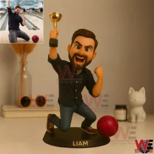 Cartoon style resin figure of a bearded man holding a trophy with a red bowling ball on a base labeled Liam!