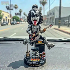 KISS demon style bobblehead figure with bass guitar on a car dashboard!