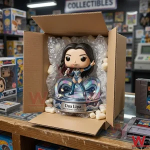 Dua Lipa Radical Optimism Pop Figure Doll 7 An open shipping box containing a female singer figure with packing peanuts and bubble wrap! The box is on a glass counter in a toy store!