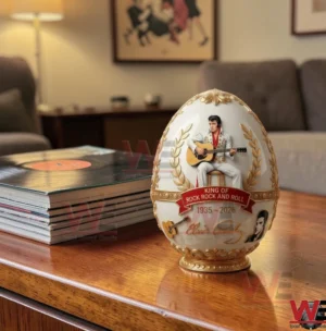 Elvis inspired white and gold decorative egg on a coffee table beside stacked vinyl records!