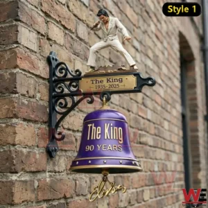 Wall mounted purple bell with performer figure and The King ninety years sign on brick wall.