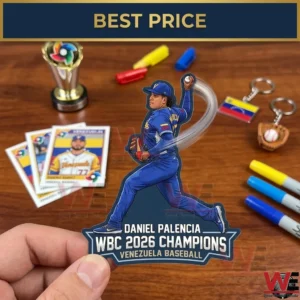 A person holds a Daniel Palencia pitching sticker celebrating the WBC 2026 victory. The wooden table below contains a trophy cards and colorful markers.