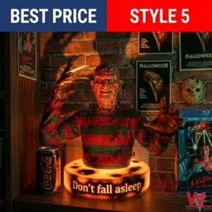 A Freddy Krueger bust with a clawed hand on a glowing orange base! The base says DONT FALL ASLEEP! There are movie posters and a soda can in the background!