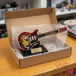 Freddie Mercury Rock Guitar Brick Set 7 A close up photo of a LEGO guitar model on a desk with rock music memorabilia!