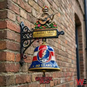 Grateful Dead sixty years wall bell with skull lightning logo mounted on a brick wall.