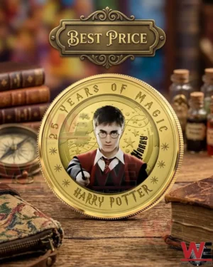 A gold Harry Potter anniversary coin sitting on a wooden desk with magical props and vintage books!
