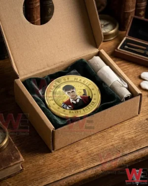 A Harry Potter gold coin packaged in a cardboard box with a velvet lining and a cleaning cloth!
