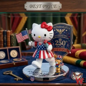 A Hello Kitty figure dressed in American flag colors holding a flag and torch on a silver base! A blue shield plaque celebrating the 250th anniversary is behind the figure! Coins and a brass key are on the blue surface!