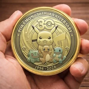 Close view of a Pokemon anniversary coin held in both hands!