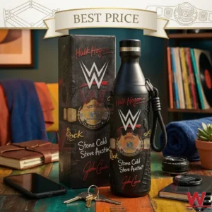 A matte black WWE collector water bottle and its original box are displayed on a wooden table. The design includes a gold championship belt and signatures from wrestling legends like Hulk Hogan and John Cena.