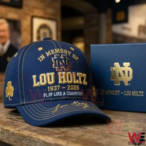 Blue Notre Dame memorial cap honoring Lou Holtz on a table beside a matching box!
