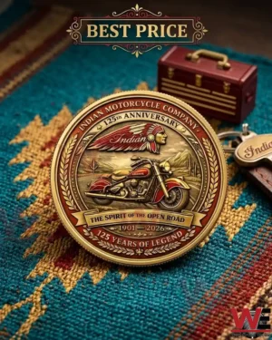 A close up of a gold Indian Motorcycle anniversary coin with intricate relief work sitting on a colorful woven rug!
