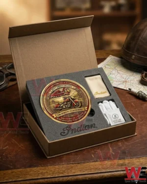 A collector set for an Indian Motorcycle gold coin including gloves and a cloth inside a presentation box on a desk!