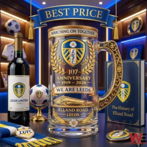 Leeds United anniversary glass beer stein on a desk with club memorabilia.