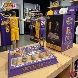 Kobe Bryant tribute display with two Lakers figures and championship style rings on a base!