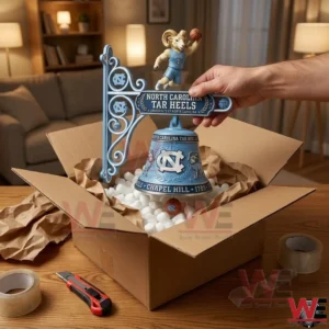 North Carolina Tar Heels Chapel Hill Wall Bell 5 Hand lifting a North Carolina Tar Heels wall bell from a gift box!