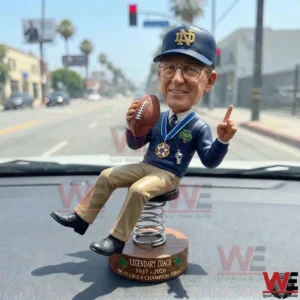 Notre Dame inspired coach bobblehead on a car dashboard holding a football!