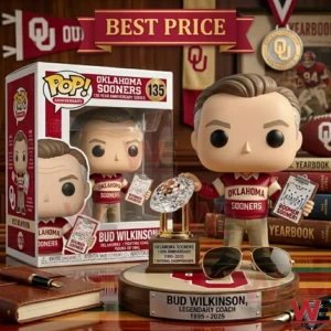 A collectible Bud Wilkinson vinyl figure with a crystal football trophy and aviator sunglasses on a wooden display base!