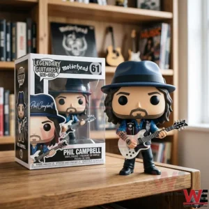 Phil Campbell Motorhead Legendary Guitarist Pop Figure Doll 3 A collectible music figure in a hat and vest holding a guitar positioned on a wooden shelf with books in the background!