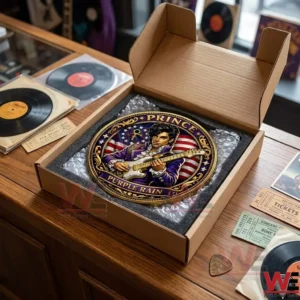 A Prince commemorative plaque packed in a cardboard box on a wooden desk surrounded by vinyl records and concert tickets!