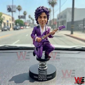 Purple musician bobblehead displayed on a car dashboard!