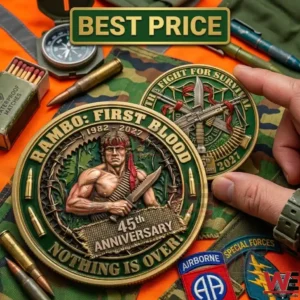 A close up of two Rambo First Blood forty fifth anniversary coins on a camouflage background! One coin shows John Rambo while the other shows military weapons and gear!