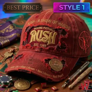Close up of a distressed red Rush band hat with gold lettering and embroidery surrounded by music memorabilia!