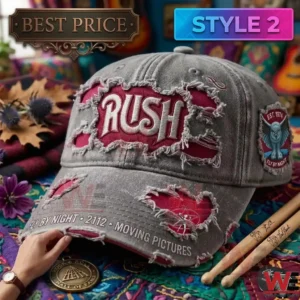 A grey vintage style Rush hat with an owl patch on the side and fanned out drumsticks on a rug!