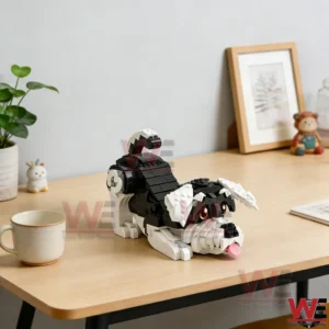 Brick built schnauzer dog model on a wooden desk near a mug and a plant!