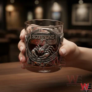 Hand holding a Scorpions anniversary tumbler with a scorpion emblem in a bar setting