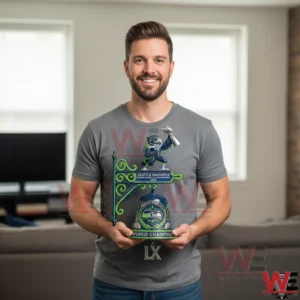 Man holding a Seattle Seahawks themed wall bell decor!