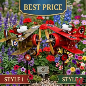 Two Snoopy biplane garden stakes one brown and one red are placed among colorful flowers! Each plane has a propeller and Snoopy in the cockpit wearing pilot gear!