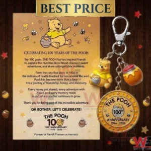 Winnie the Pooh 100th Anniversary keychain with honey pot and Pooh charms next to a celebratory card.
