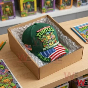 Commemorative turtle cap in a cardboard shipping box.