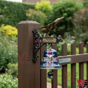 Top Gun 1986-2026 40th Anniversary Wall Bell 4 Top Gun Danger Zone bell hanging on a wooden fence post in a garden!