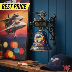 Top Gun themed wall mounted bell on a blue wall near aviation decor!