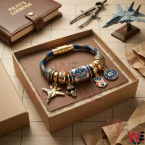 Top Gun charm bracelet inside a brown cardboard box on a desk with a logbook and a model airplane!