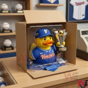 A photograph of the Venezuela champion rubber duck in its original plastic packaging inside a cardboard box.