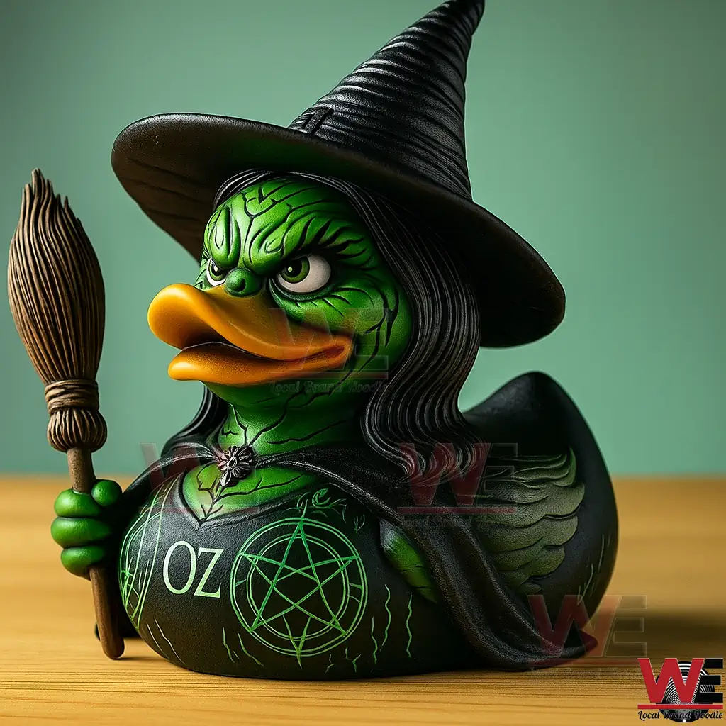 Wicked Witch of the West OZ Witch Duck 2 A green witch rubber duck with a black hat and broomstick sitting on a wooden table.
