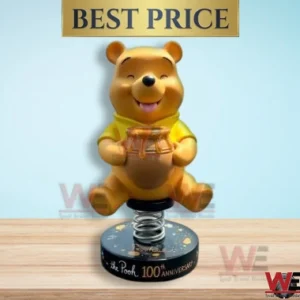 Winnie the Pooh bobblehead holding a honey pot on a 100th anniversary base.