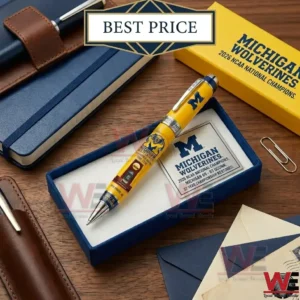 Commemorative Michigan Wolverines 2026 National Champions pen in a blue gift box on a desk.