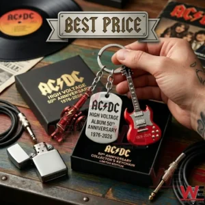 Close up of a limited edition AC DC 50th Anniversary keychain set held over a wooden table with rock music memorabilia!