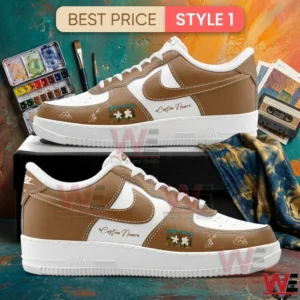 Side view of custom brown and white sneakers with flower patches and signatures sitting on a black box!