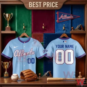 Front and back views of a custom light blue Atlanta baseball jersey inside a wooden locker filled with sports equipment.