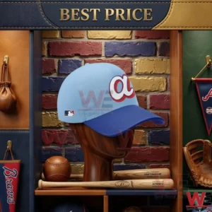 A light blue and navy baseball hat with a team logo on a wooden display head in front of a multicolored brick wall.